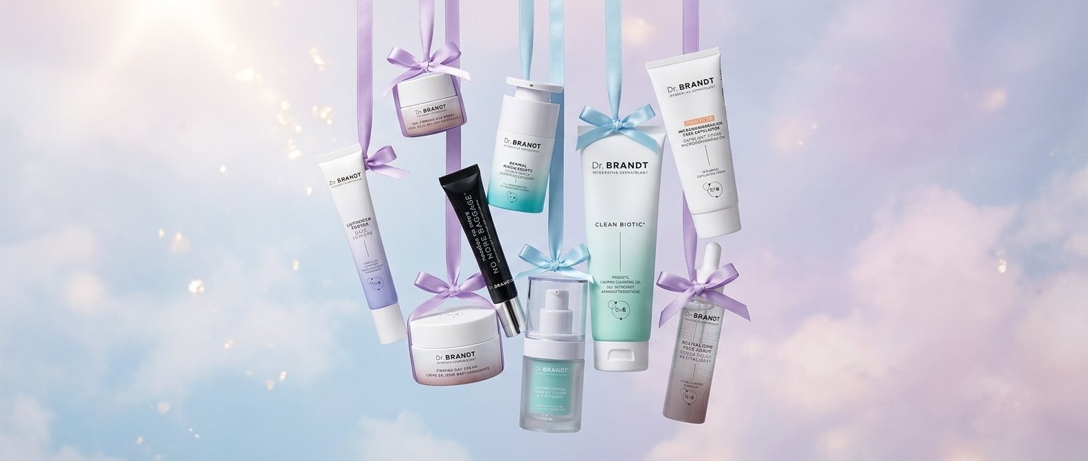 Nine Dr. BRANDT bestsellers hanging from lavender and blue ribbons against a pastel winter sky